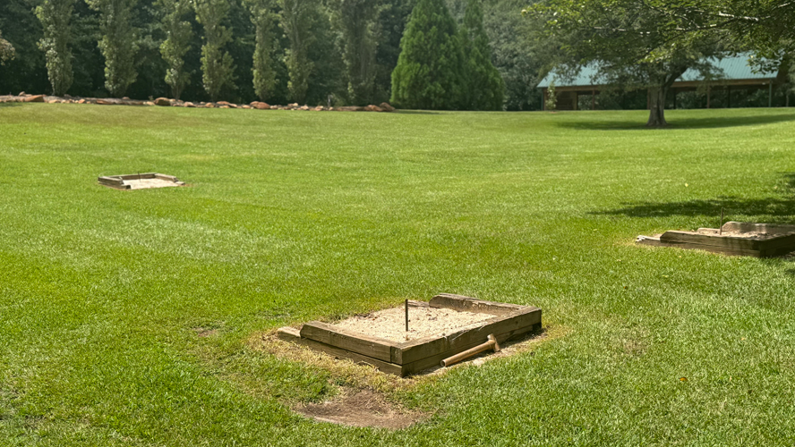Horseshoe pits are located next to the pool area.